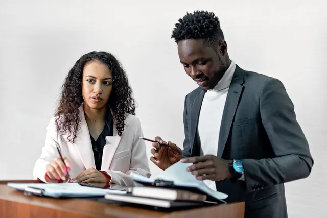 Business professionals signing a contract together, symbolizing collaboration. Picking a supplier for gaming creator work, from fit and evidence to trial and exit